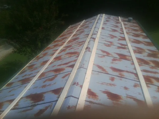 Rusted metal roof panels with new wood purlins before replacement — Storm Damage Roof Repair in Whitmire by Roofing Brothers