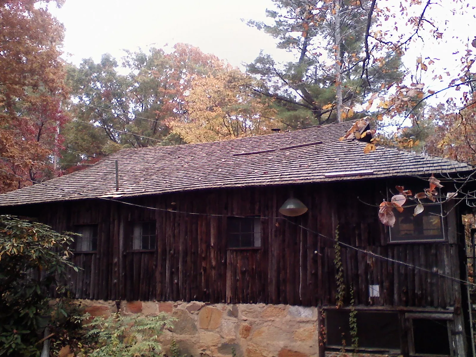 Weathered wood shake roof on a rustic board sided cabin in Whitmire